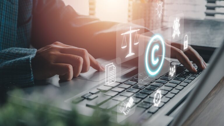 Person using laptop computer on desk with VR screen_s