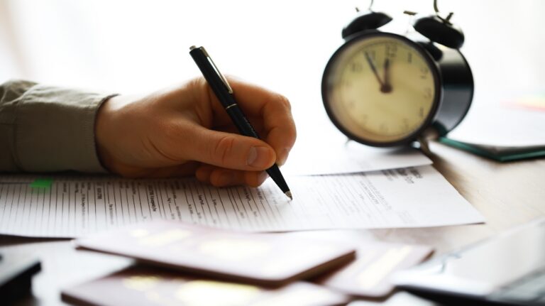 clock and paperwork on desk
