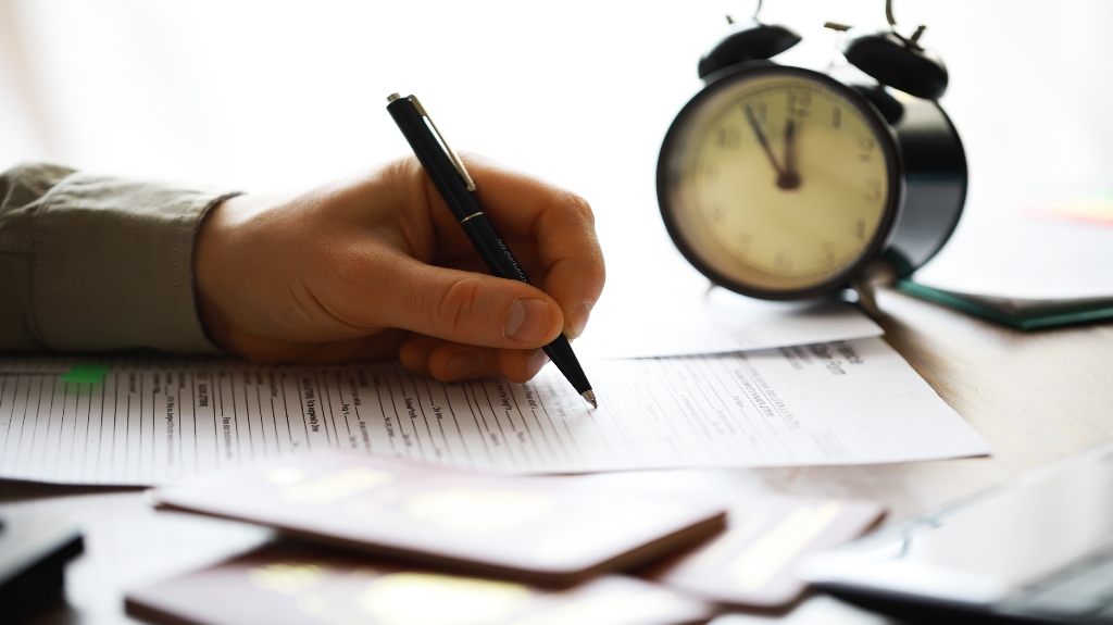 clock and paperwork on desk